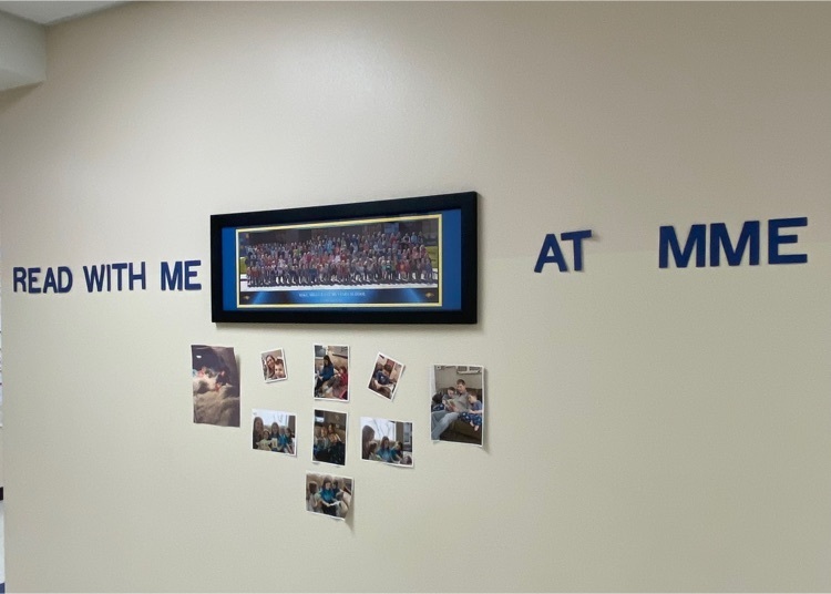 Pictures of students reading at home displayed on the wall.