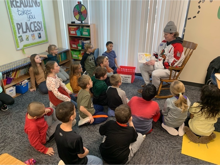Children listening to Wings player read.