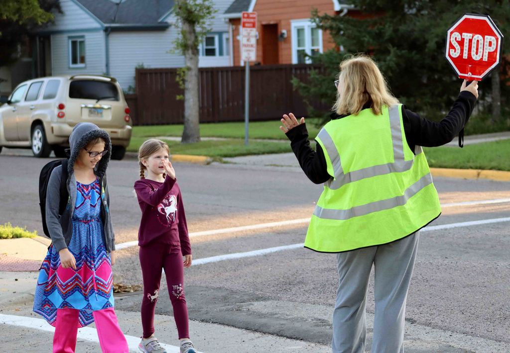 Simmons Elementary student waving at a crossing guard