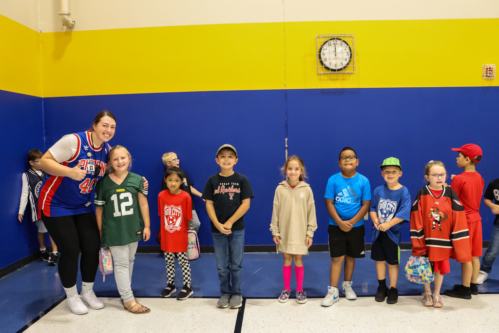 Mike Miller Elementary teacher and students dressed in jerseys and hats